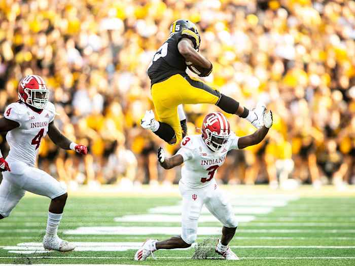 Iowa's Tyler Goodson hurdles an Indiana defender